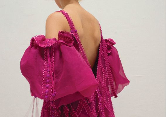 A woman dressed in a pink dress