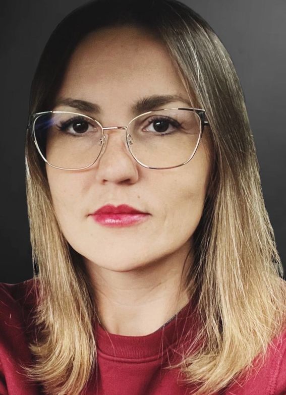 Elena wearing glasses and a red sweater.