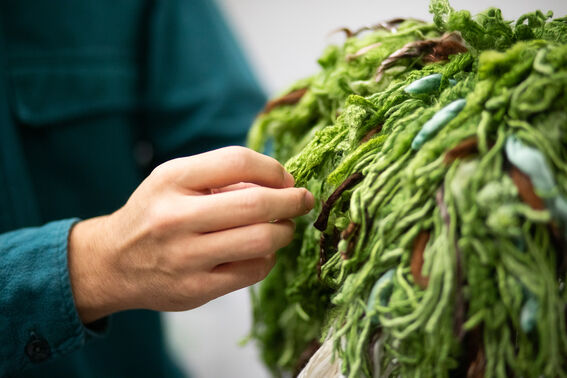 Testikangas, jossa näkyy vihreällä ja ruskealla värjättyjä kuituja. 