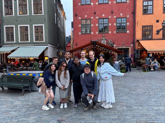 Interns gathering in a European city square 