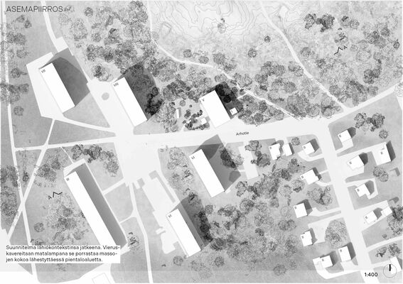 A black and white architectural site plan showing multiple buildings surrounded by trees and roads in a suburban area.