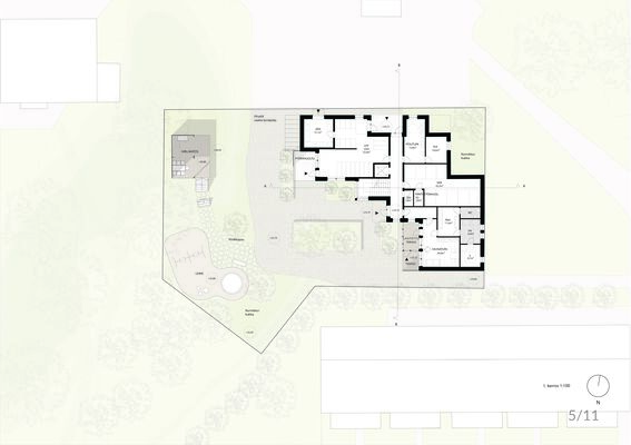 Architectural floor plan showing a detailed layout of a building, outdoor grill area, playground, and surrounding landscape.