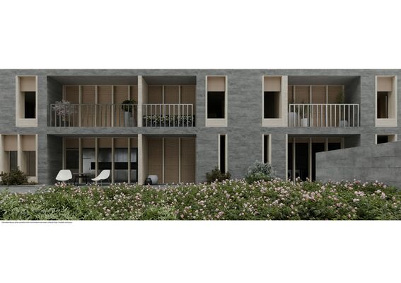 Modern grey apartment building with balconies, large windows, and a lush garden with blooming flowers in the foreground.