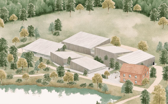 Aerial view of modern wooden buildings and a brick house, surrounded by trees and located near a river.