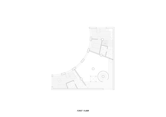 Architectural floor plan of the first floor, featuring curved walls, rooms, furniture, and a spiral staircase.