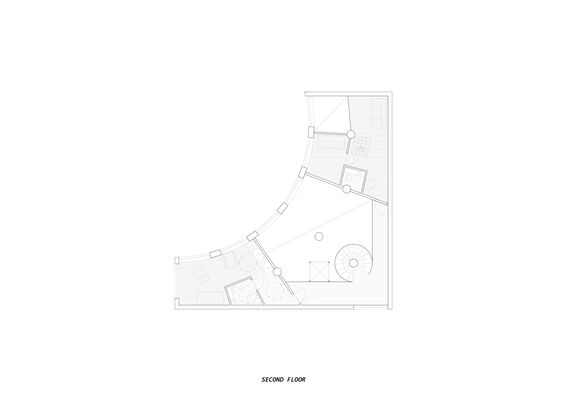 Architectural floor plan of the second floor, featuring curved walls, rooms, furniture, and a spiral staircase.