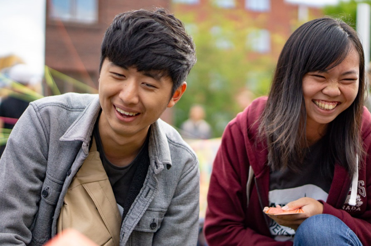 Two students laughing together.