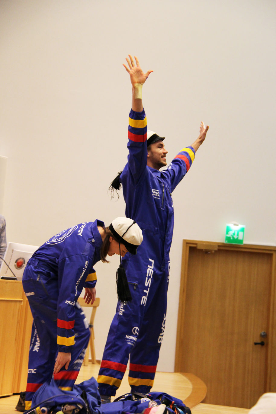 An image of two students wearing blue overalls