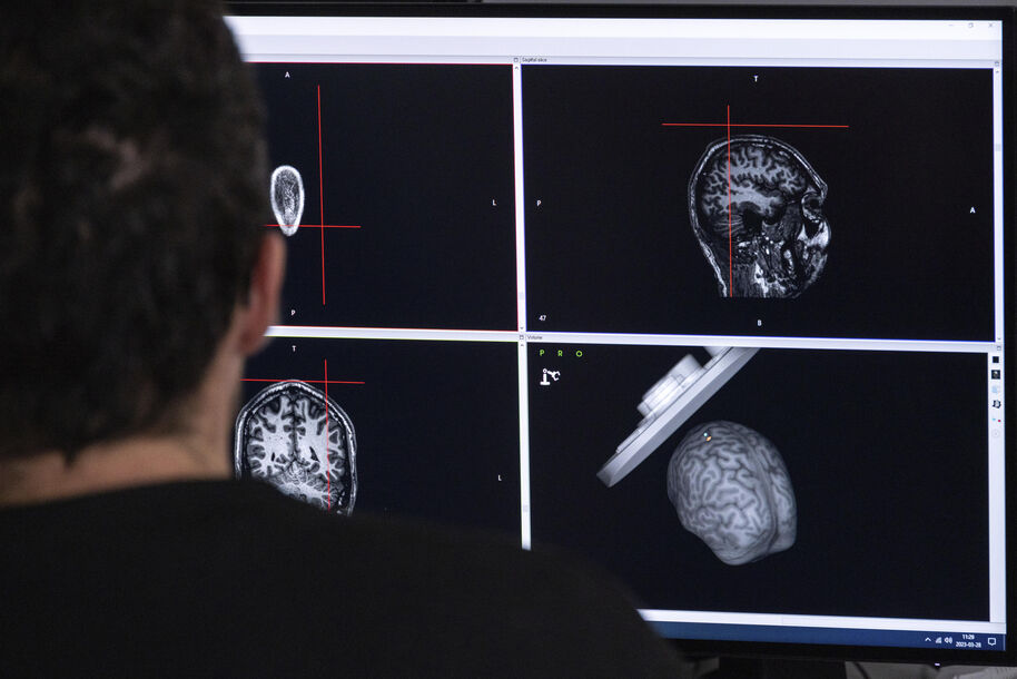 A man watching brain images on a screen