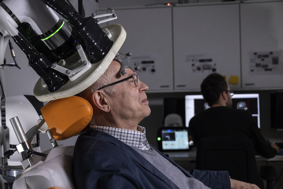 a man sitting in a magnetic stimulation machine