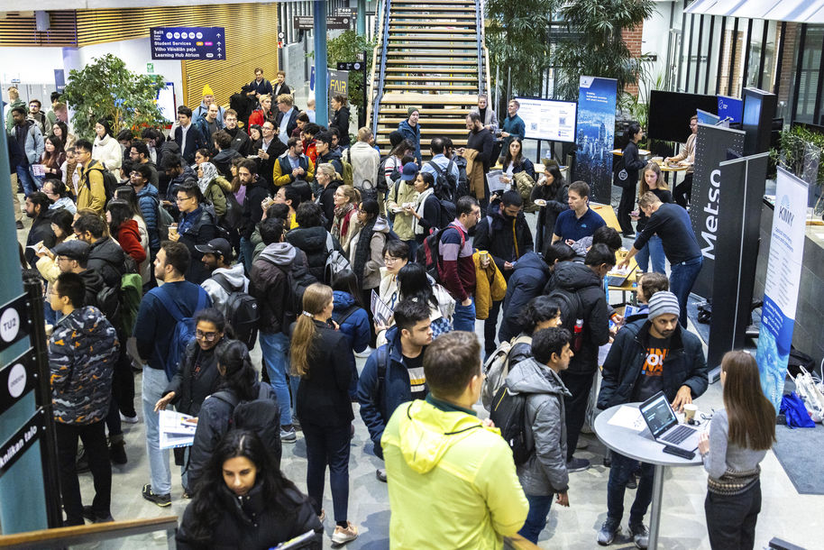 University students at a networking event in a lobby.