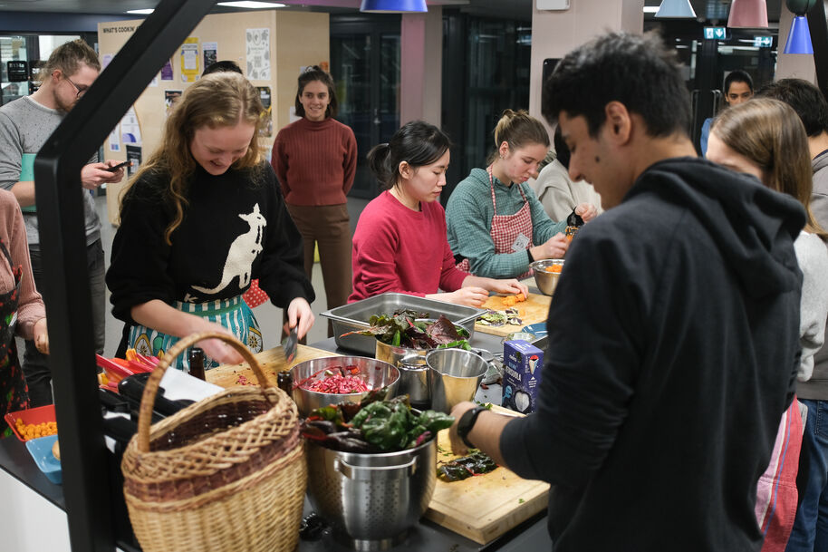 Students preparing food at an Aalto Foodsharing community cooking event at Design Factory.