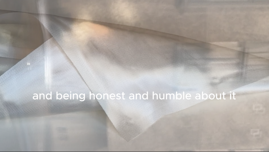 Soft grey fabric with white text in the centre reading: and being honest and humble about it