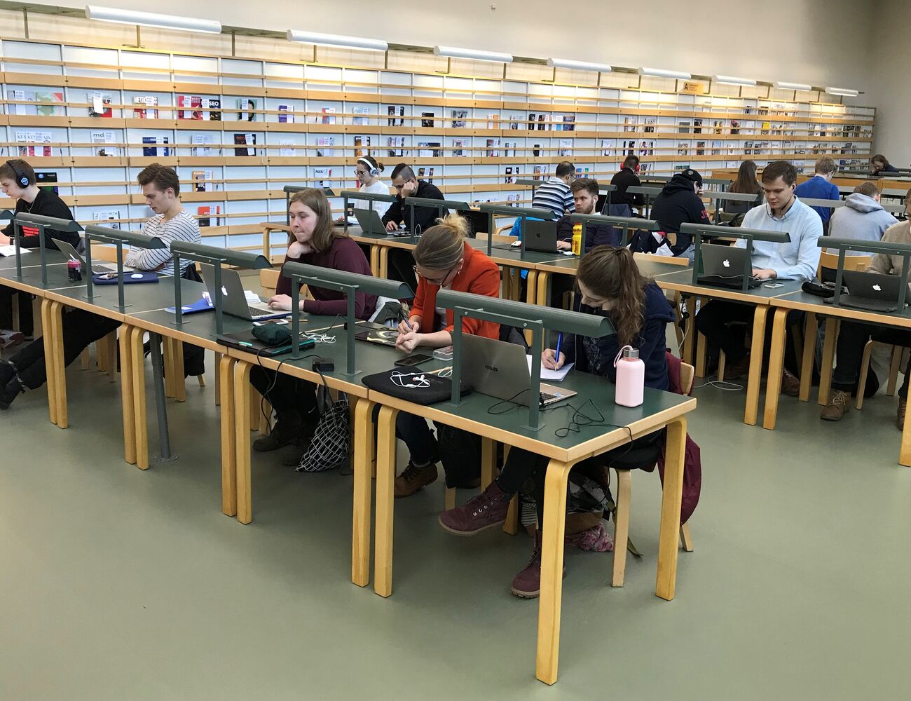 Kuva opiskelijoista opiskelemassa Oppimiskeskuksen 2. kerroksessa, lehtilukusalissa.