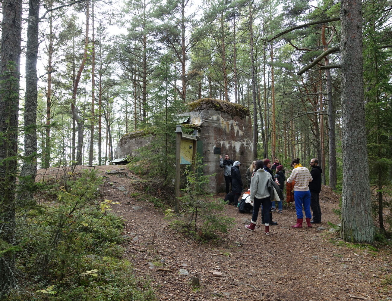 Students gather outside an old military bunker, in the middle of a forest, on the island of Reposaari