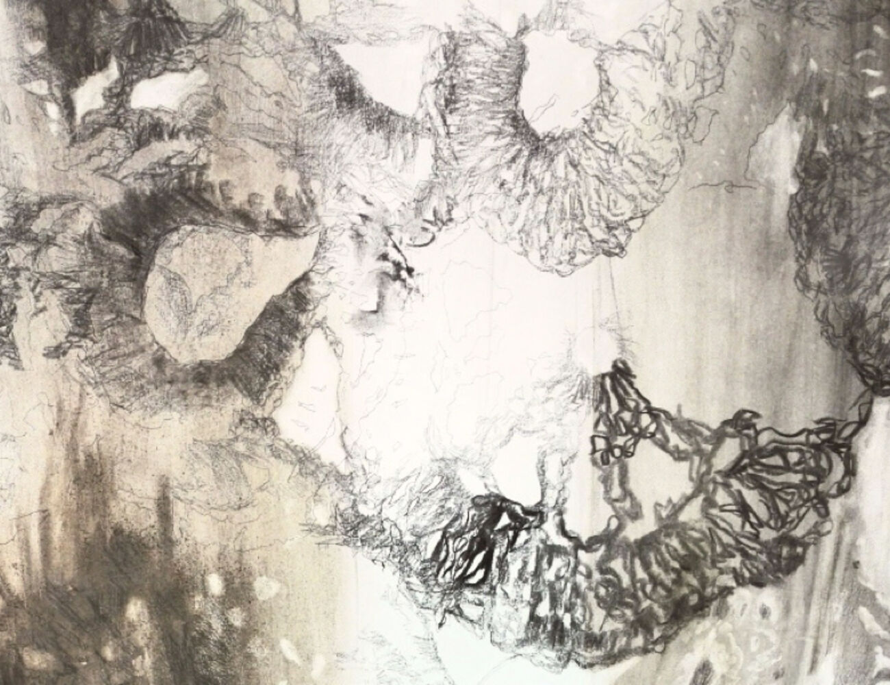 Detail of the artist's work comprised of mark-making made with charcoal, ash, pencil on paper / OHP, crochet pieces