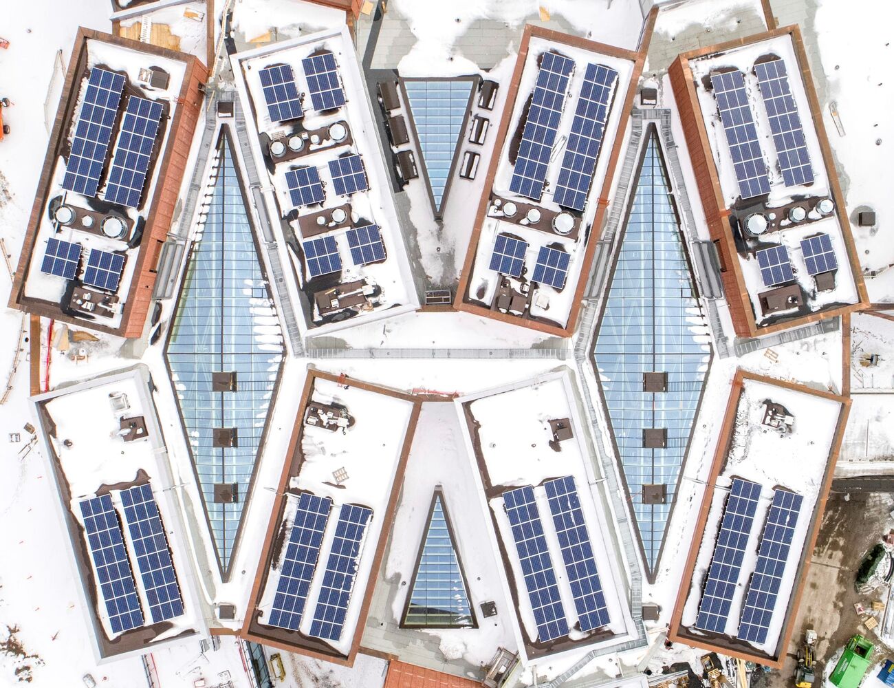 Aerial view in winter of Väre and School of Business buildings during contruction, solar panels in view