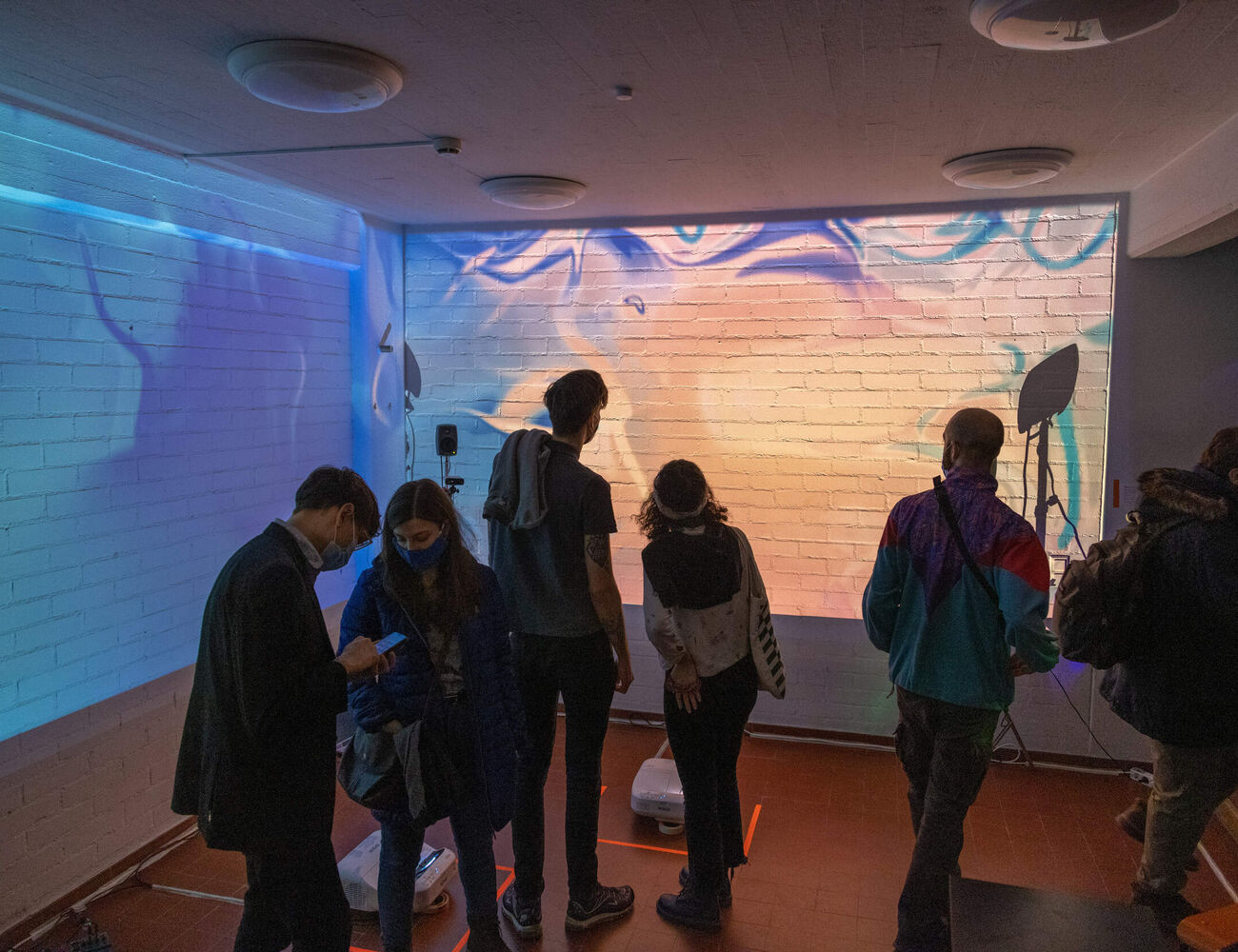 Students in front of the interactive digital mural in Space 21.