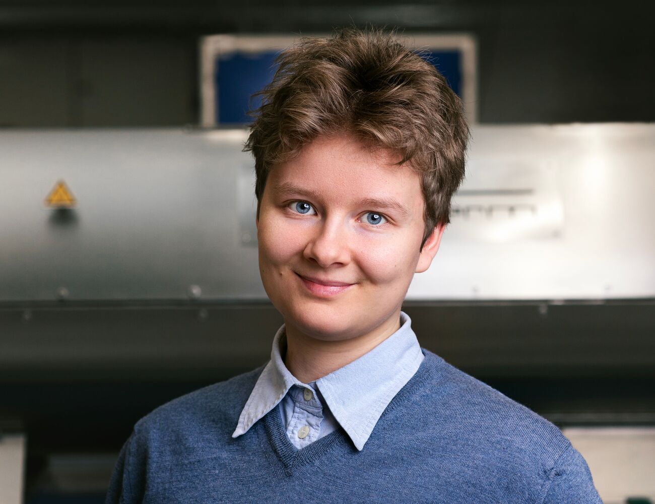 Helena Sederholm photographed in a lab setting, wearing a blue sweater.