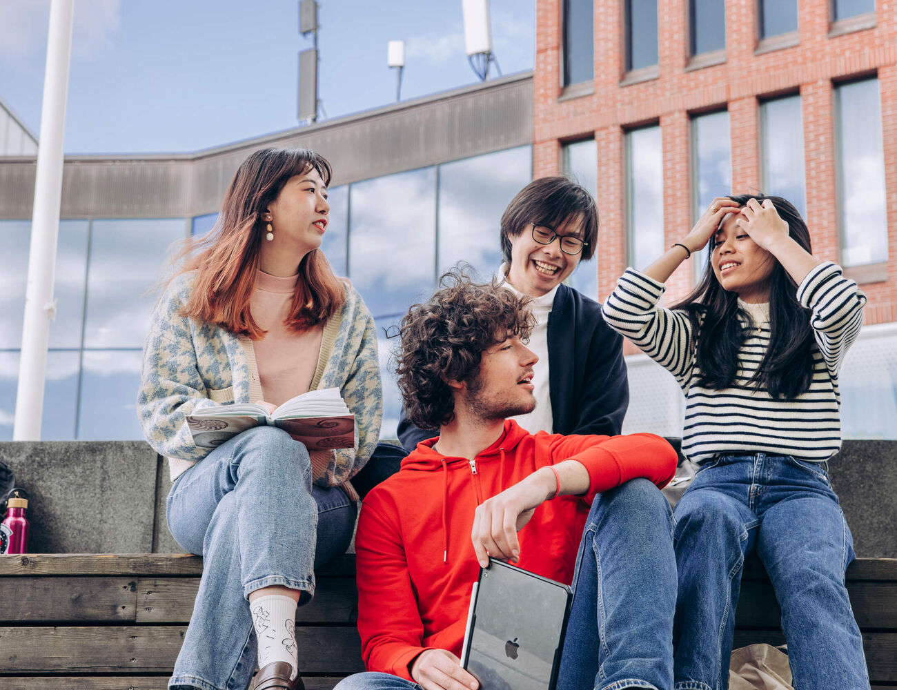 Diverse learners chatting outside the Väre building