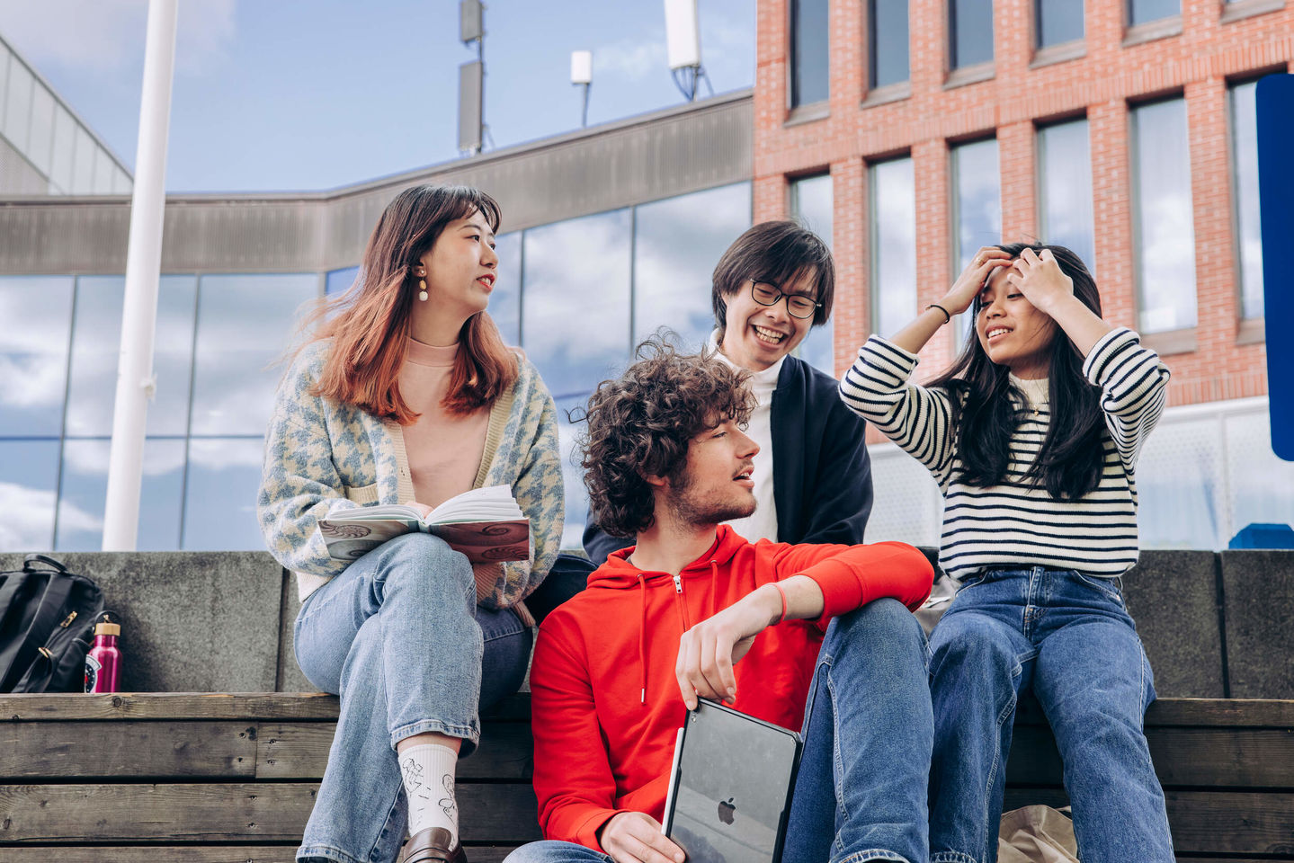 Diverse learners chatting outside the Väre building