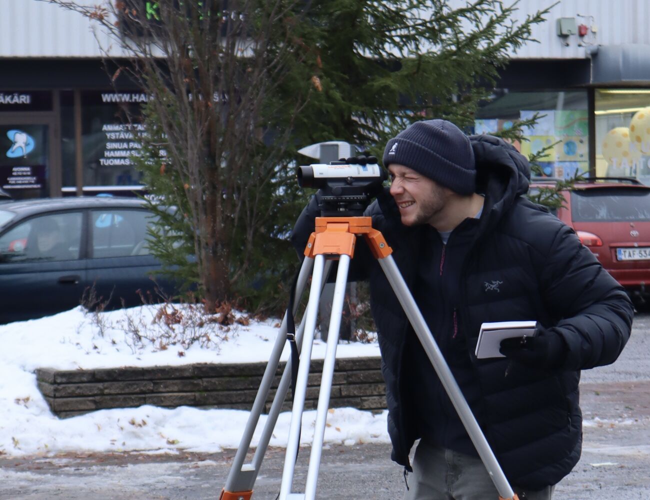 A member is doing topographic surveying