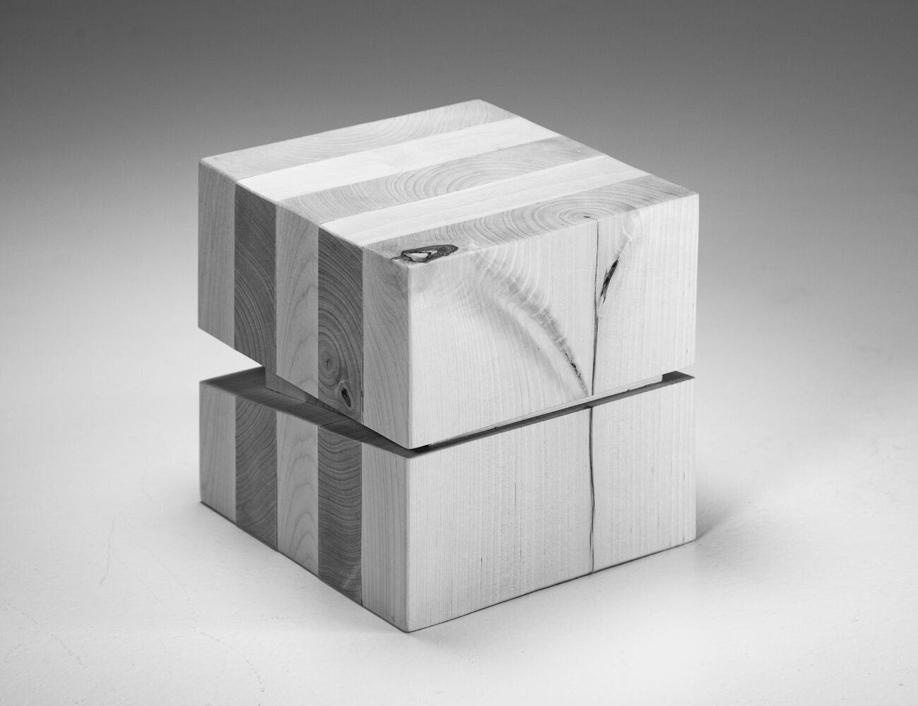 cube with alternately oriented wooden boards, and a decorative knot on one side that resembles a flower