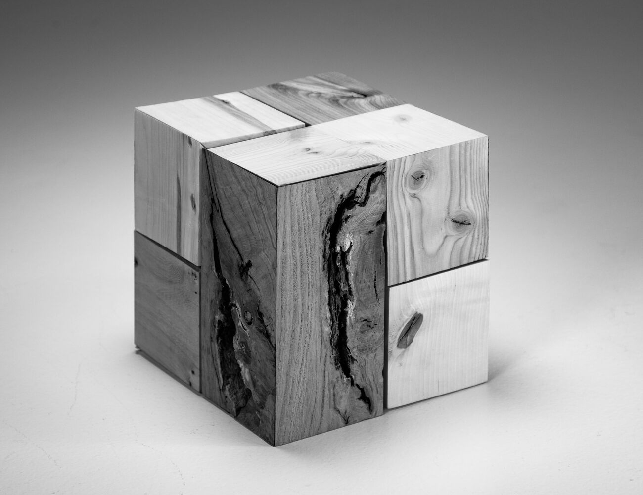 cube made of different species interlocking wooden pieces