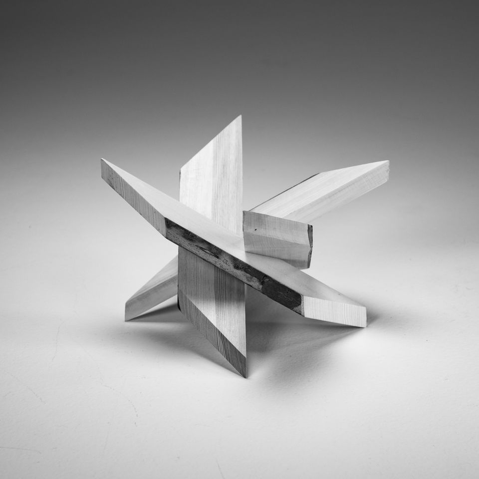 wood sculpture made of four pieces that slide together.