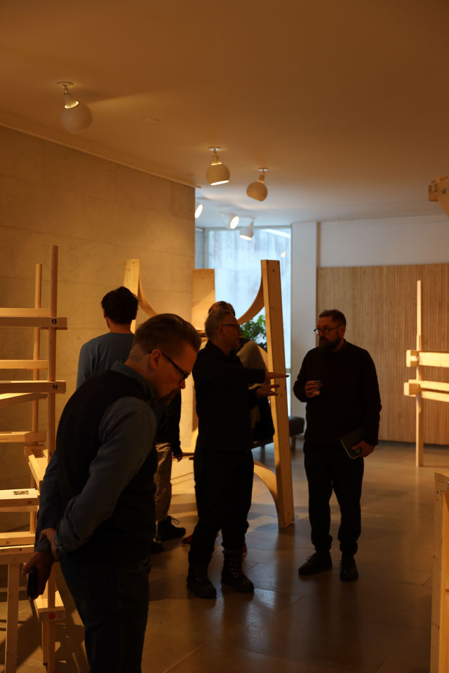 Visitors walking around and looking at the exhibition