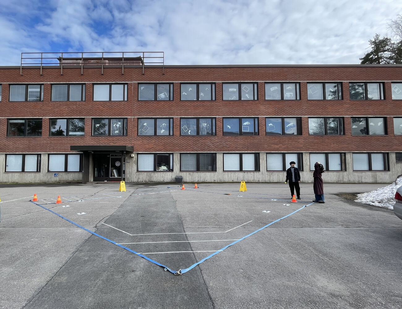 The stage layout marked with cargo straps, tape and traffic cones on a parking lot