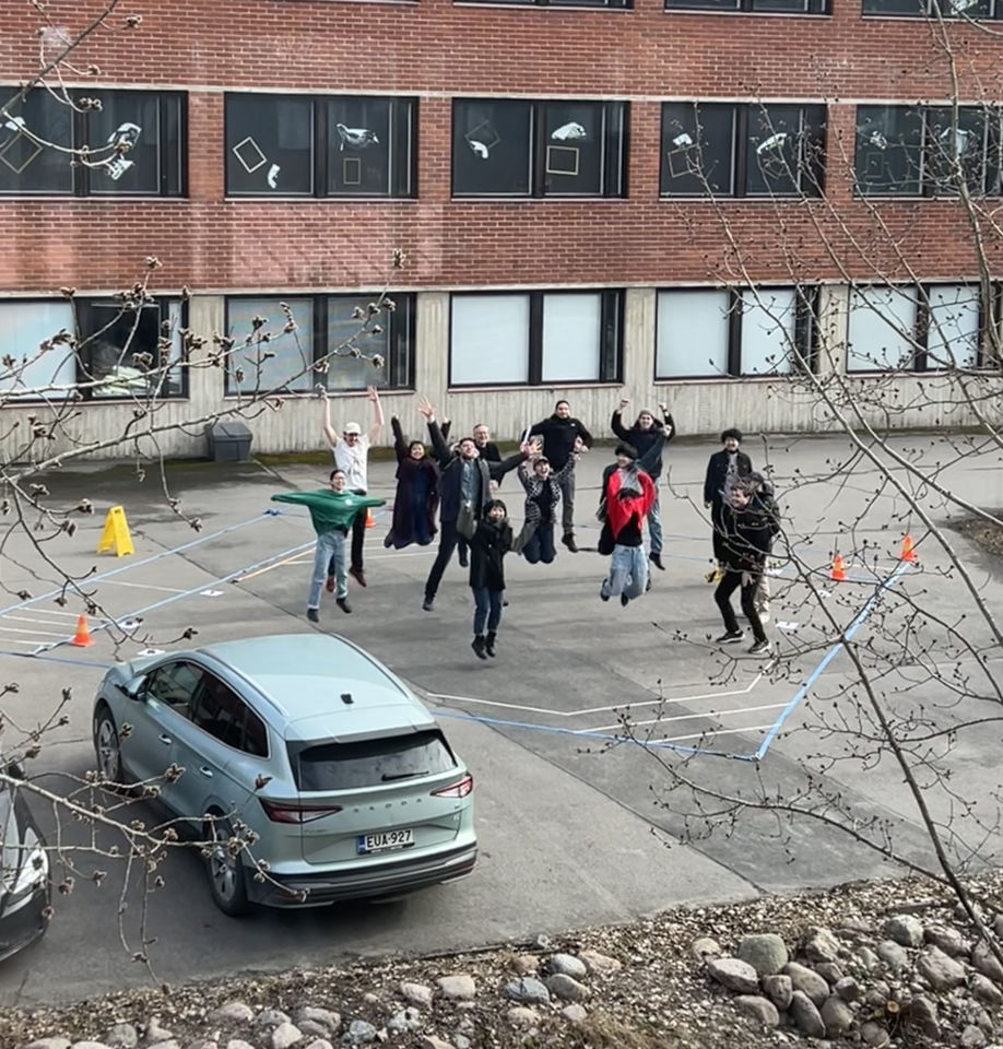 Students jumping simultaneously for the camera, all mid-air