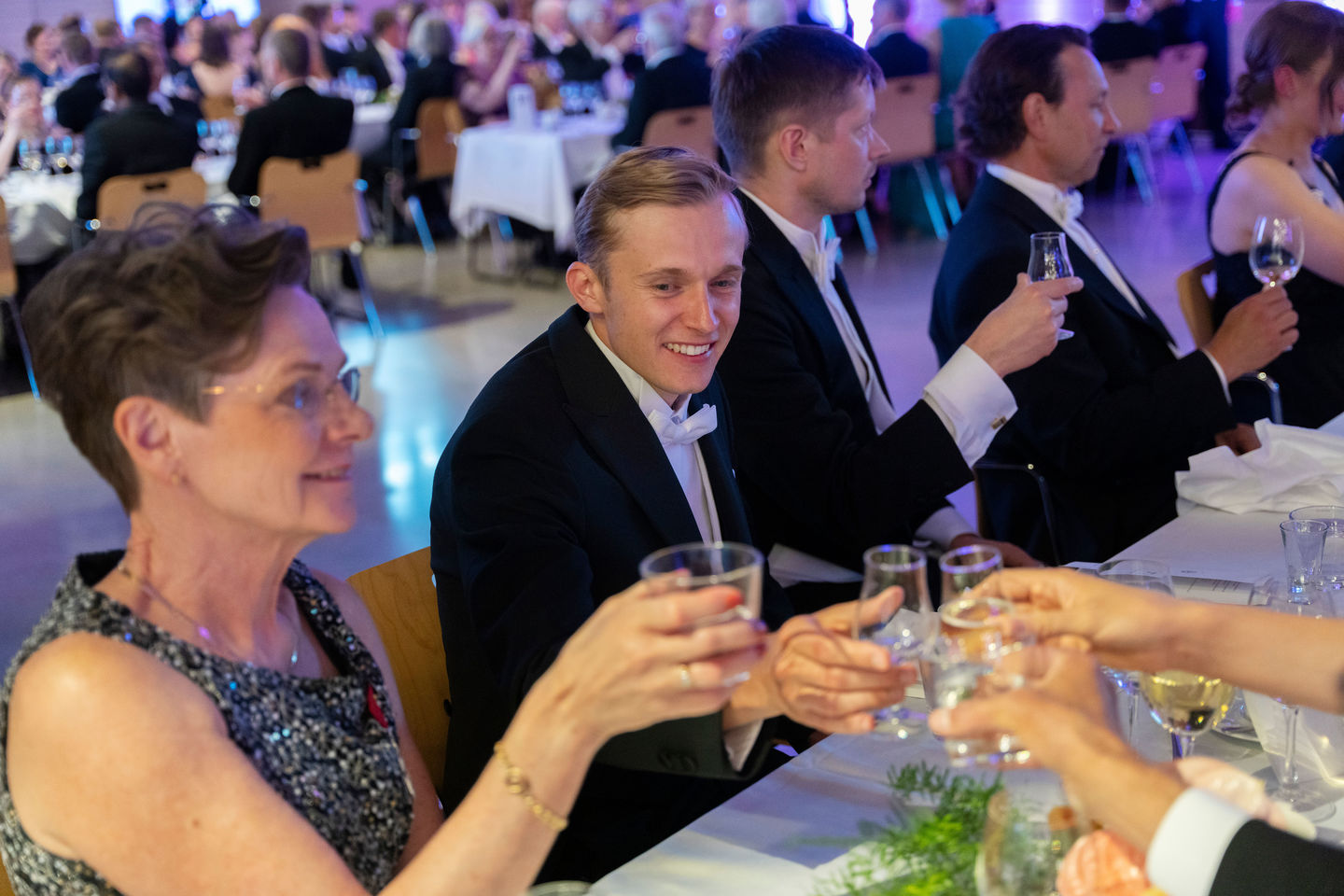 Smiling people sitting on a formal dinner