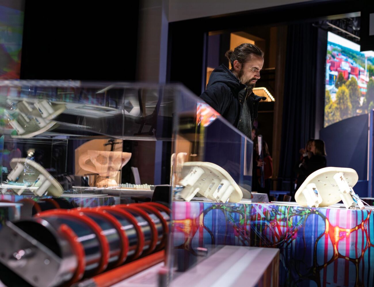 A display with various scientific instruments including a helical coil and anatomical models, in an exhibition setting.