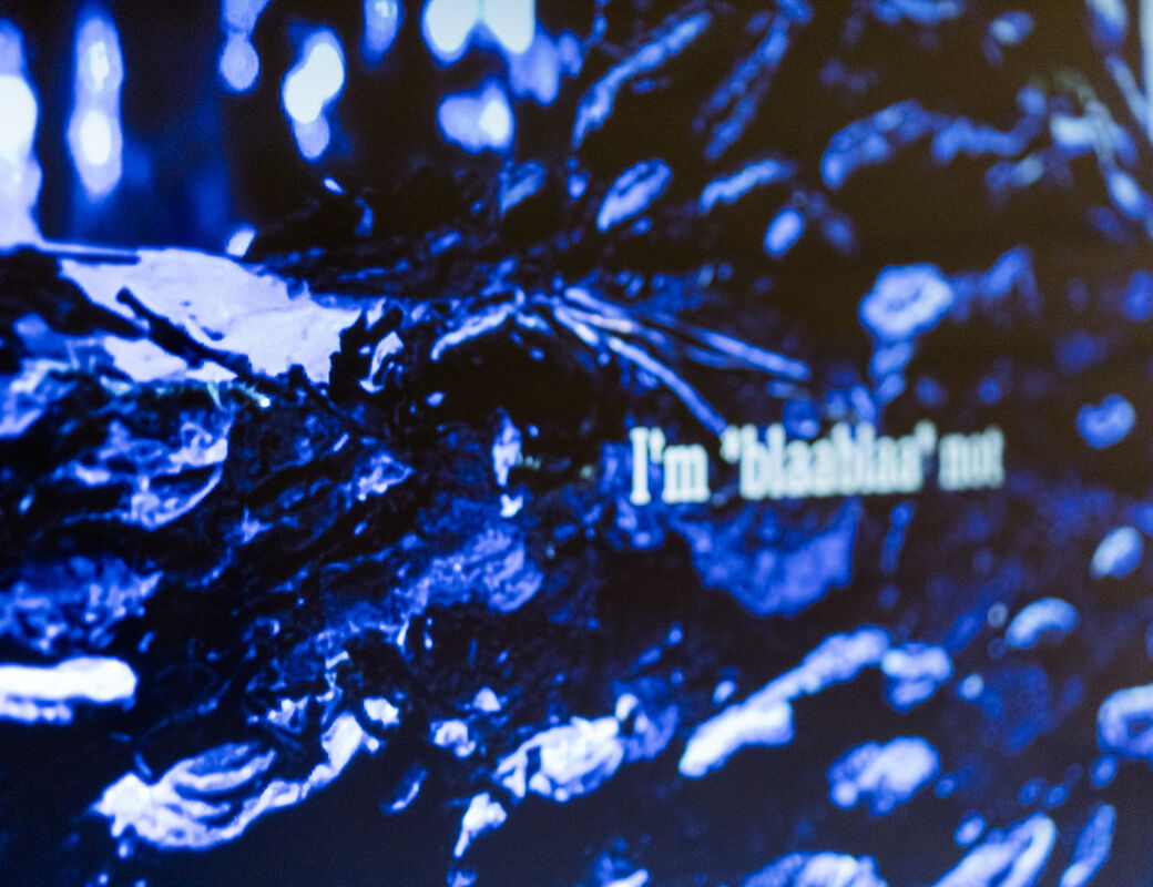 Close up of a digital piece showing swirls of blue and some fictional text laid over the top
