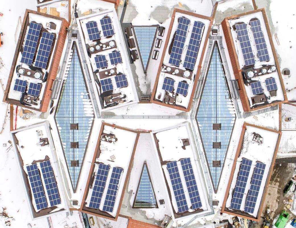 Aerial view in winter of Väre and School of Business buildings during contruction, solar panels in view
