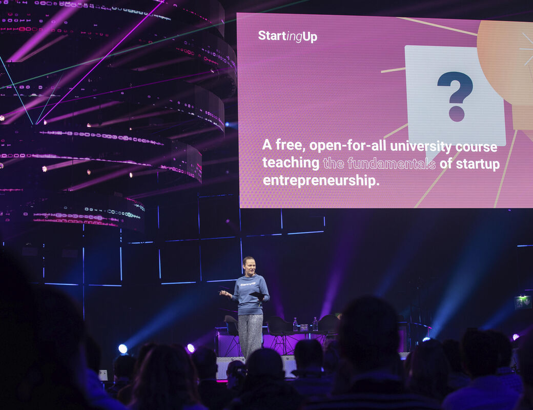 A woman stands on a stage at Slush in 2019