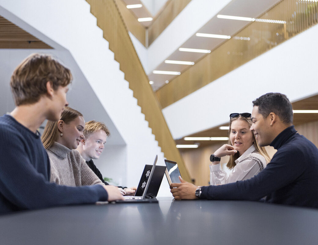 Five School of Business students doing team work