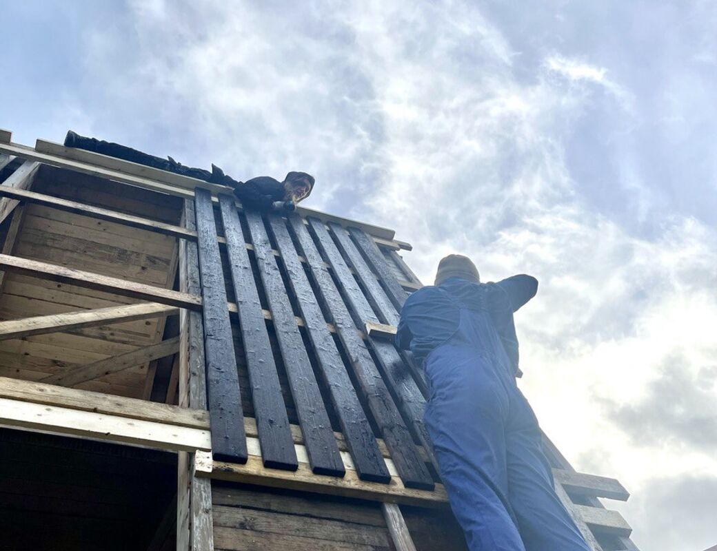 Charred wood for communal building project in action