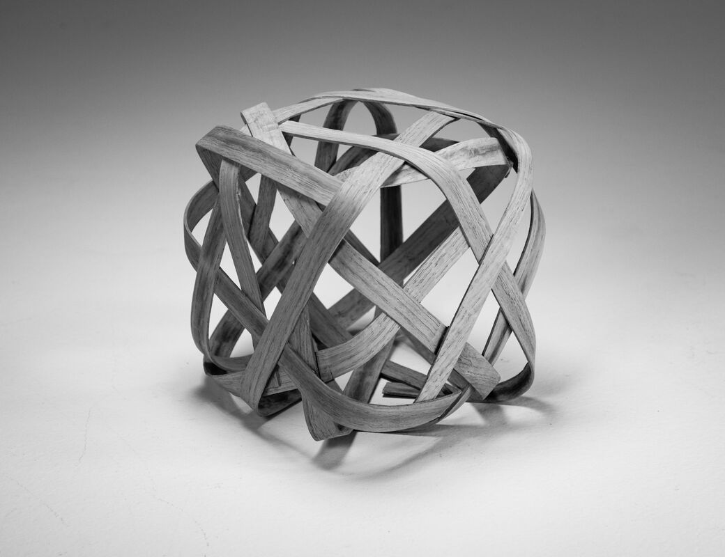 wood cube made by bending strips and gluing in square shape