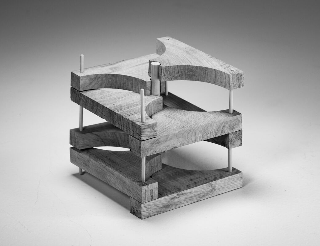 wood sculpture consisting of different layers that are interlocked with wooden dowels