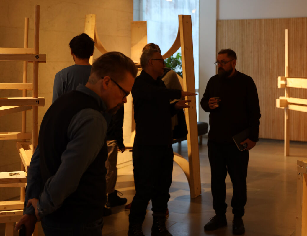 Visitors walking around and looking at the exhibition