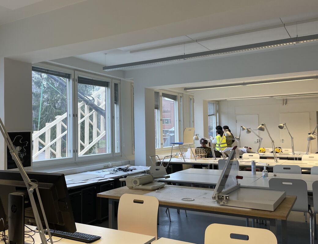Students watching through a window as the truss is being lifted