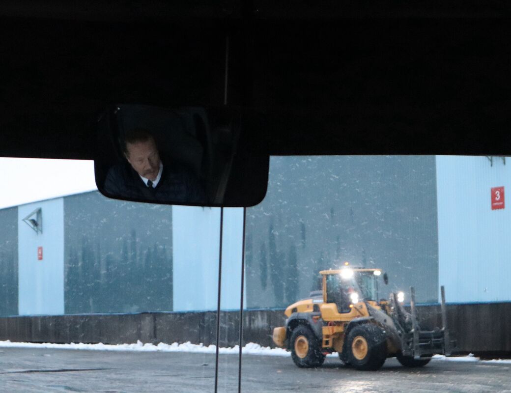 Reflection of the bus driver in the mirror