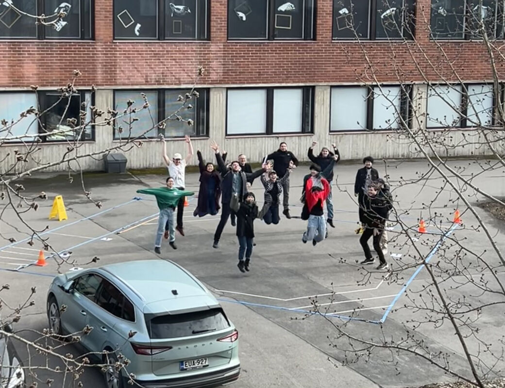 Students jumping simultaneously for the camera, all mid-air