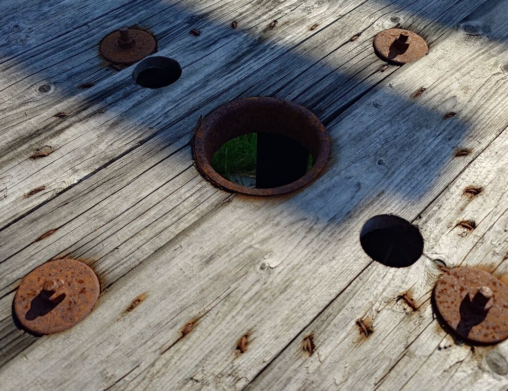 Rusty metal on grey wood