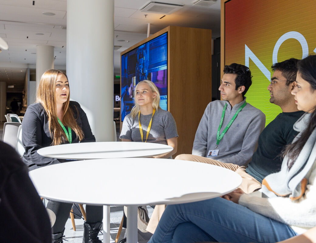 Group of people sitting around a table.