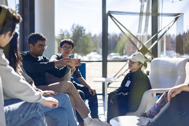 Group of students sitting on a lobby lounge.