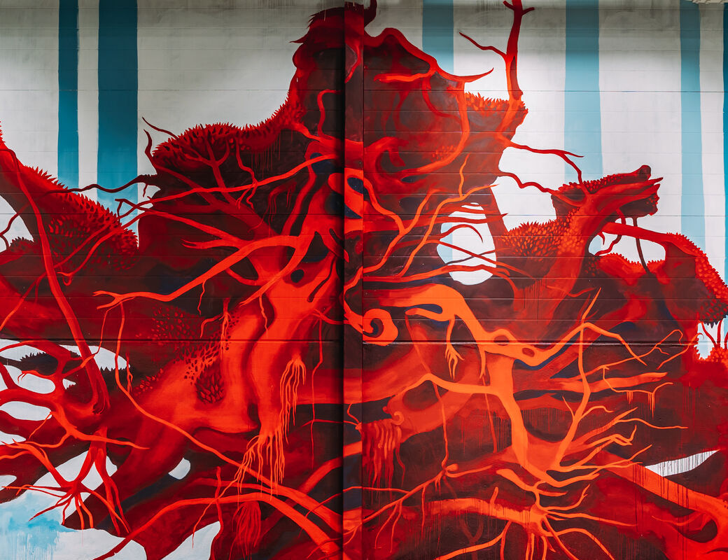 Saara Salmi painting in Keran Hallit. Deep red roots spread out across the wall