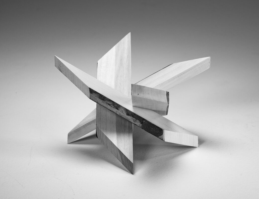 wood sculpture made of four pieces that slide together.